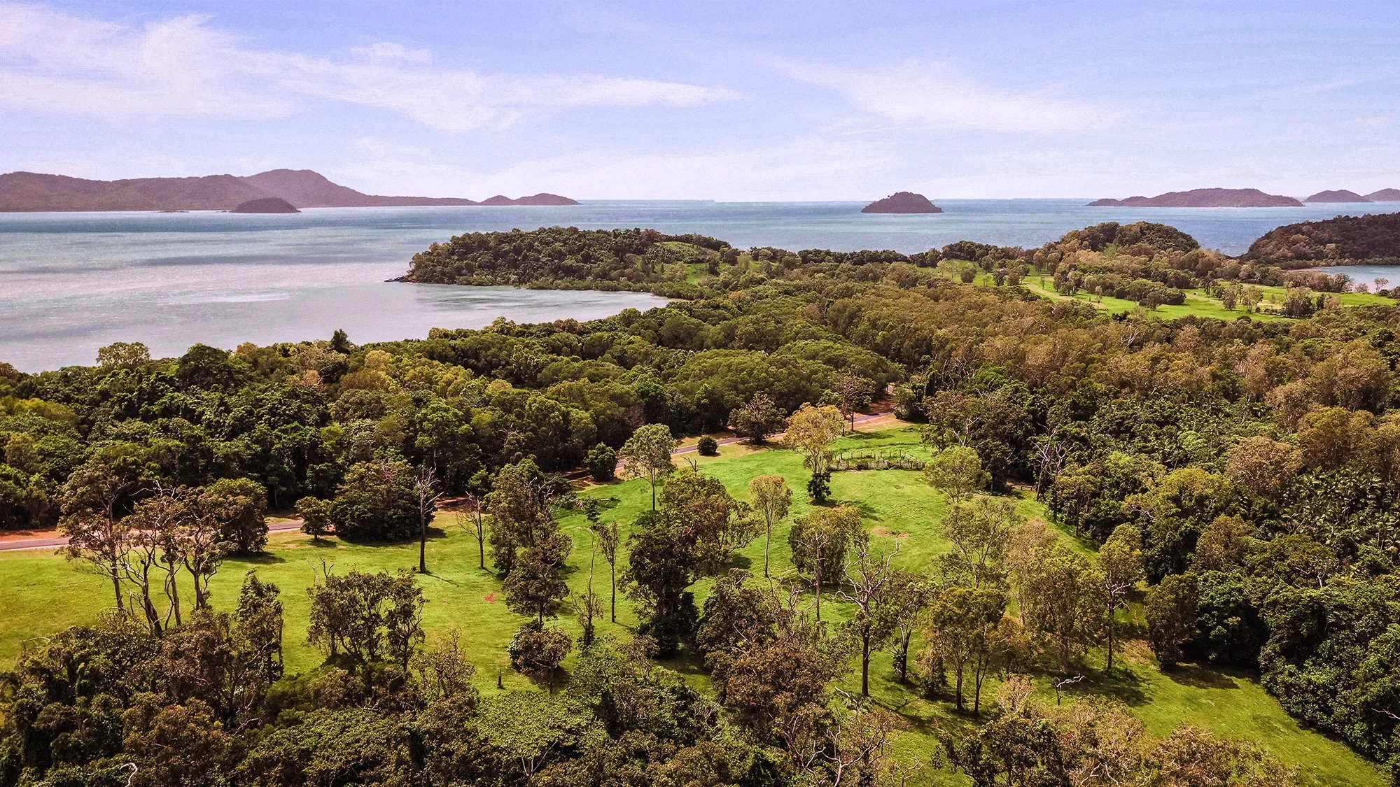 The Family Islands seen across the bay from the Headland estate at Tam O'Shanter Point: Dunk, Kumboola, Thorpe and Bedarra on the horizon.